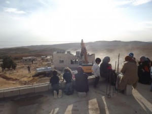 Palestinian women and children watch the demolition of a home in Ad Deirat, which is located in the south Hebron Hills (photo: Operation Dove)