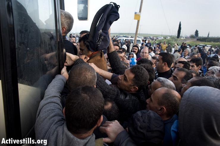 Palestinian workers with Israeli work permits try to board a 'Palestinian-only' bus. Credit: Oren Ziv/Activestills.org